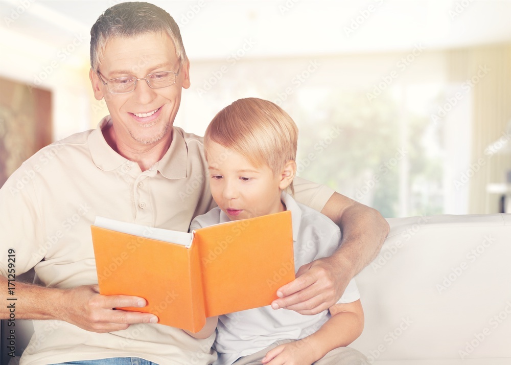 Dad and child read book.