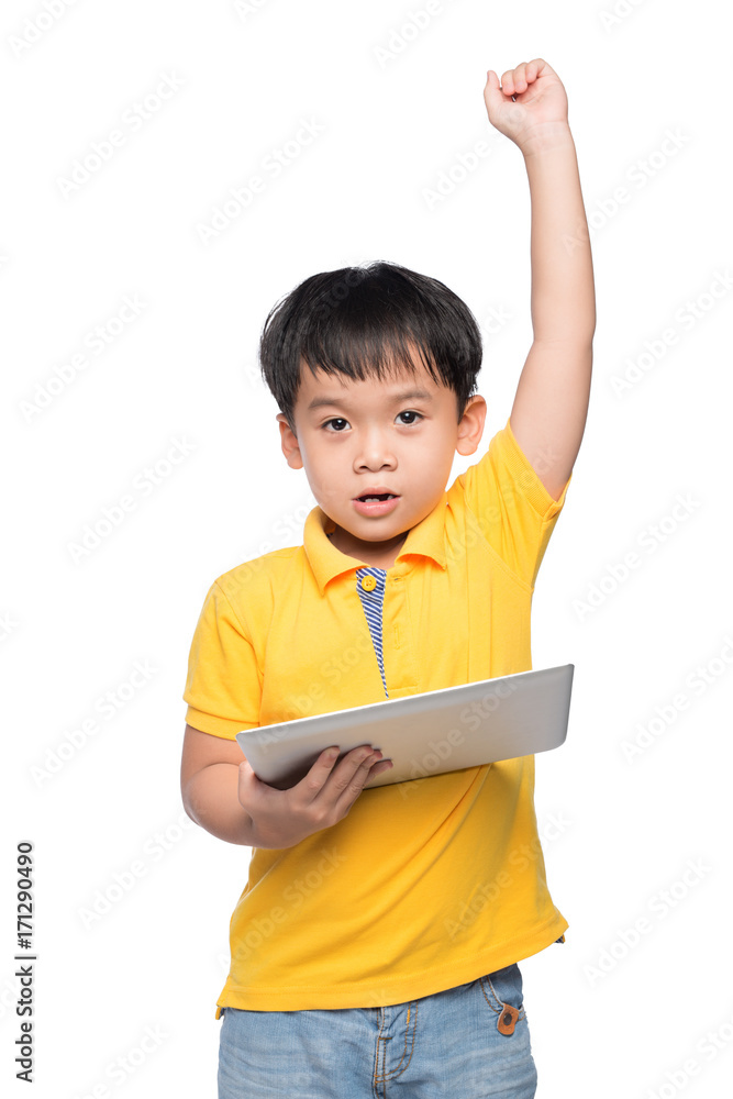 Portrait of cheerful boy with backpack holding digital tablet with hand raised