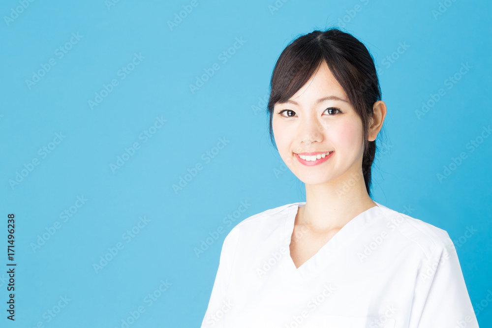 portrait of asian nurse isolated on blue background