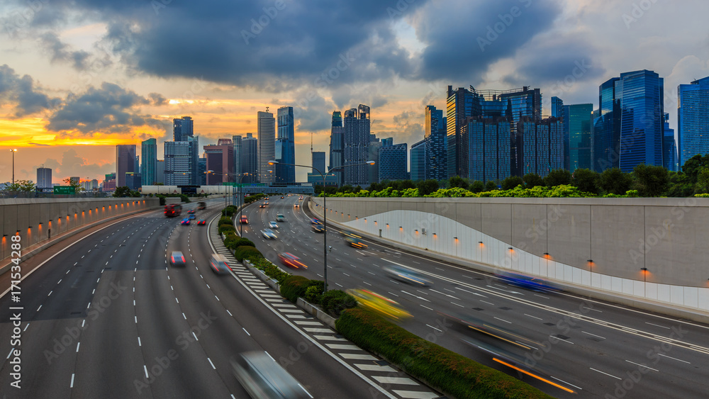 通往新加坡城的道路，日落时新加坡城市景观天际线的车灯运动。