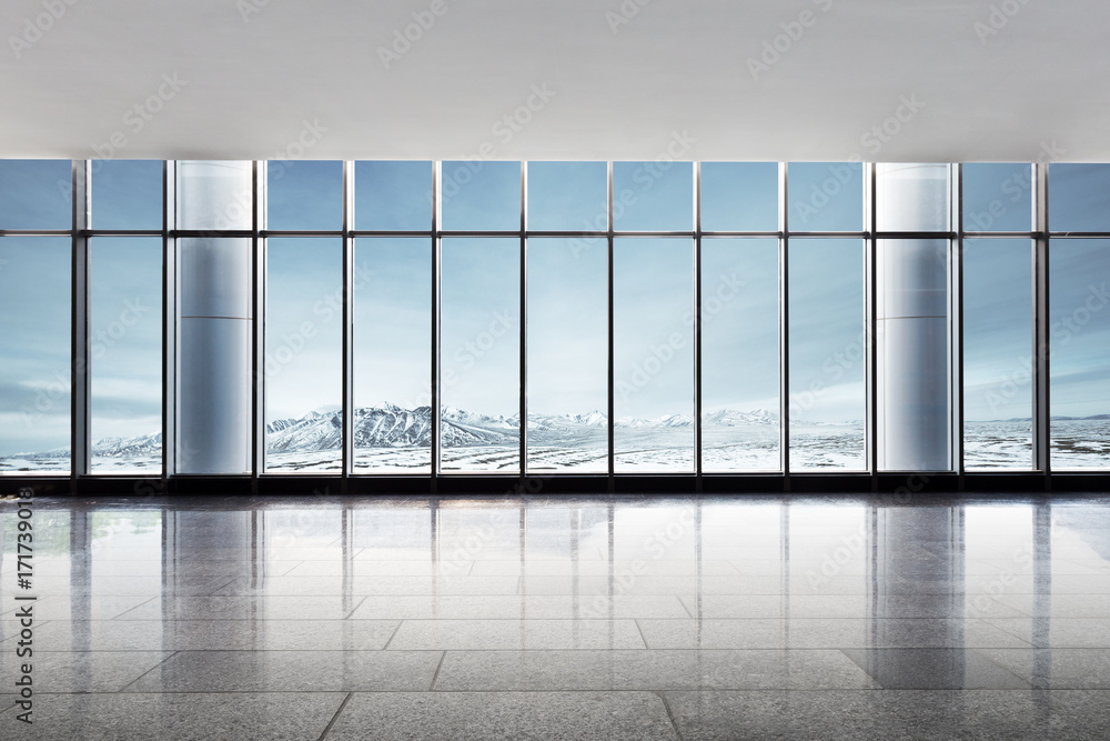 empty office with snow mountains out of window