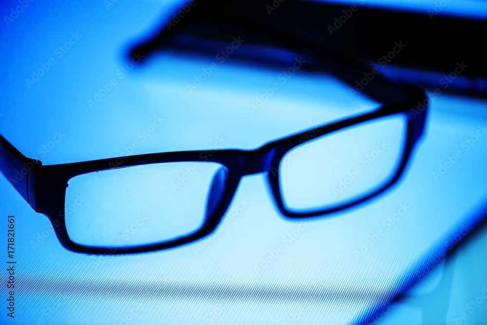 Eyeglasses on the digital desk