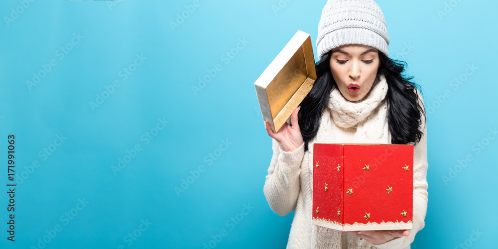 Happy young woman opening a Christmas present box