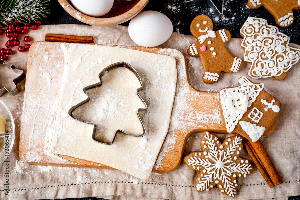 cooking christmas gingerbread on wooden background top view