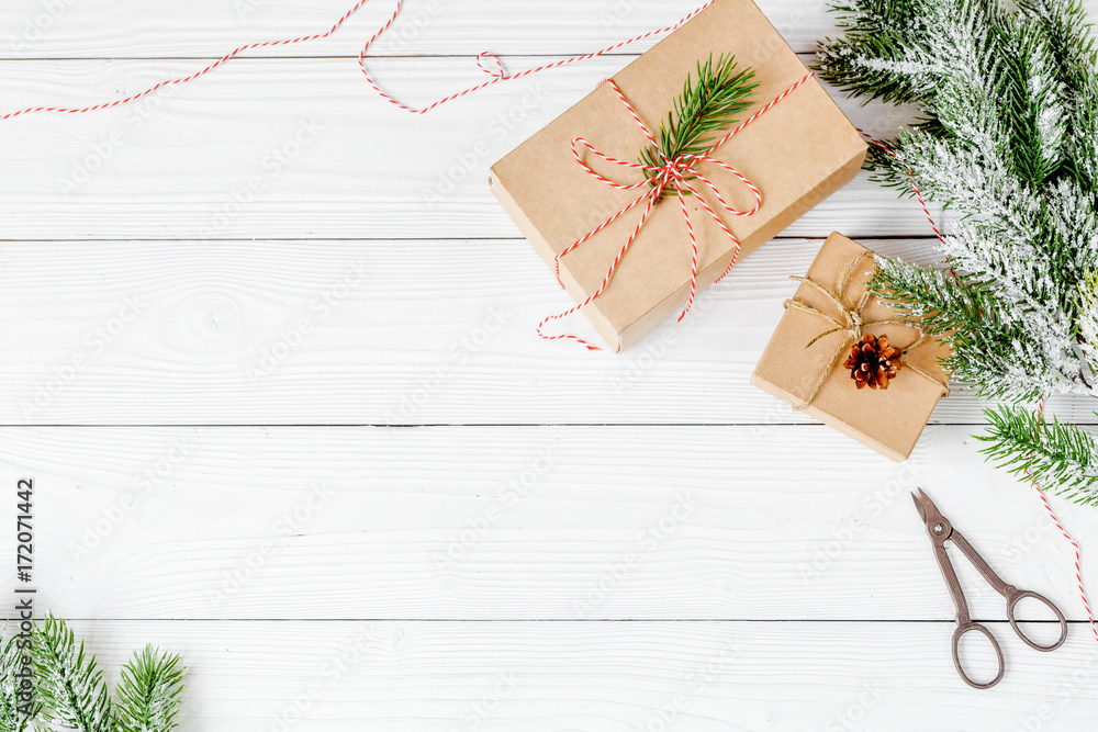 gifts boxes with fir branches on wooden background top view