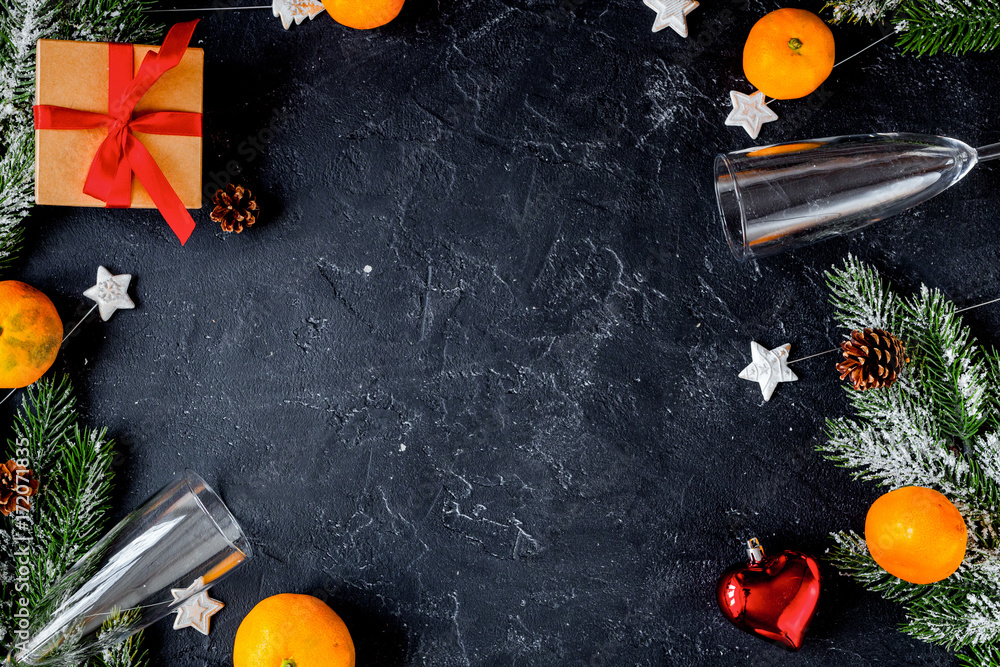 glasses and Christmas ornaments on dark background top view