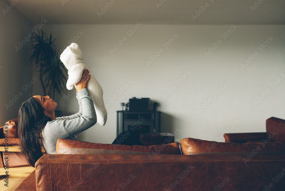 Woman playing with her baby boy at home