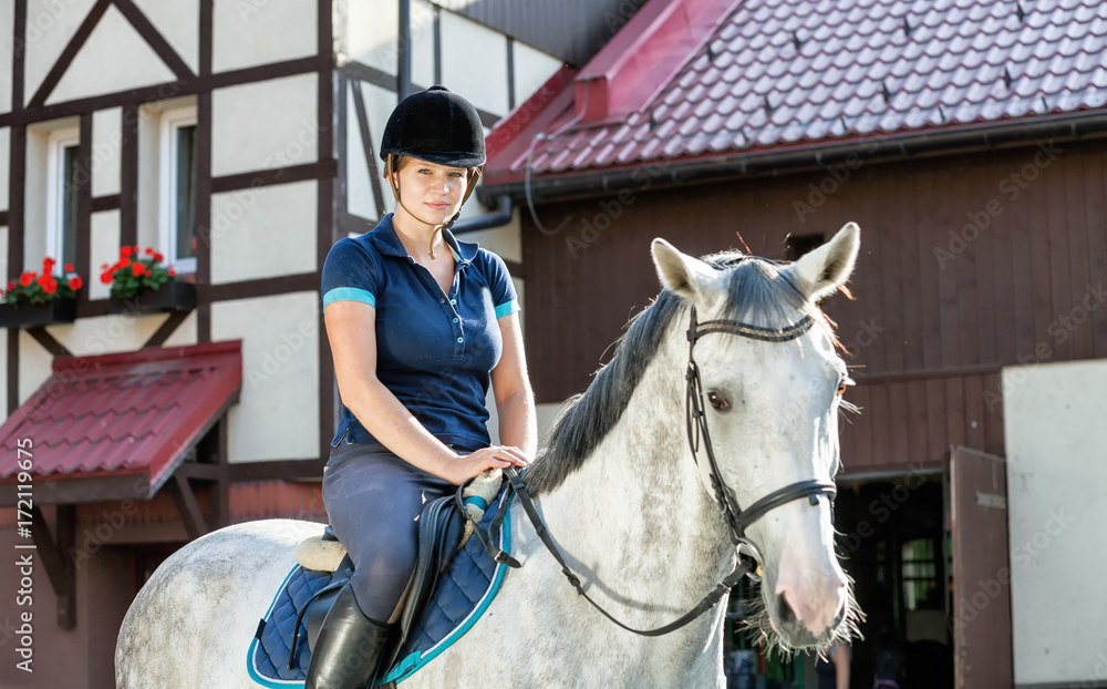 Horse rider woman near stable horsewoman before training