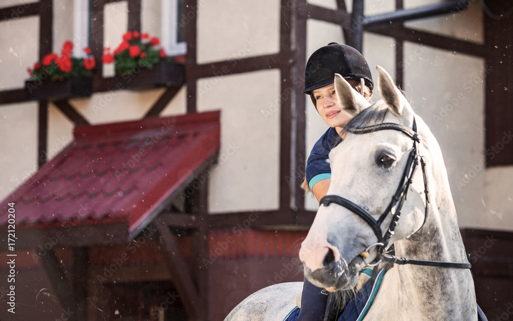 Horse rider woman near stable horsewoman before training