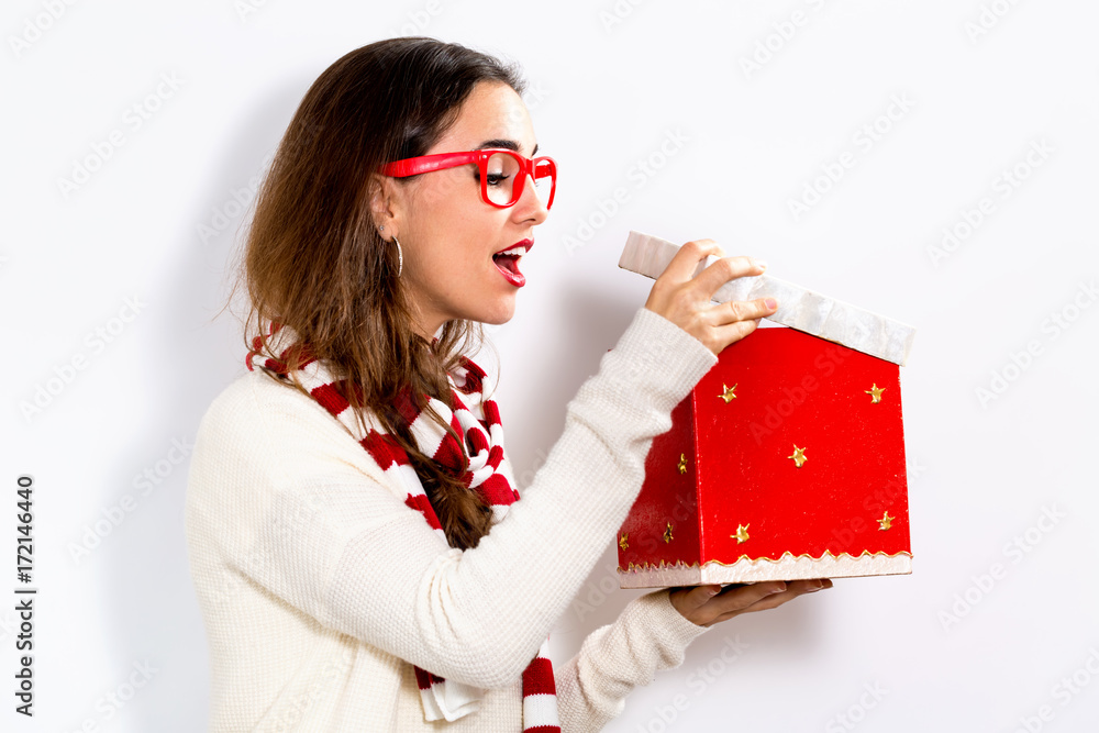  Happy young woman opening a Christmas present box