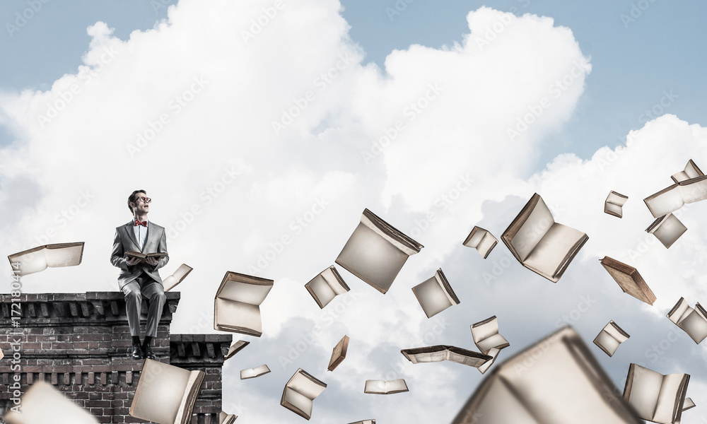 Young businessman or student studying the science and books flyi