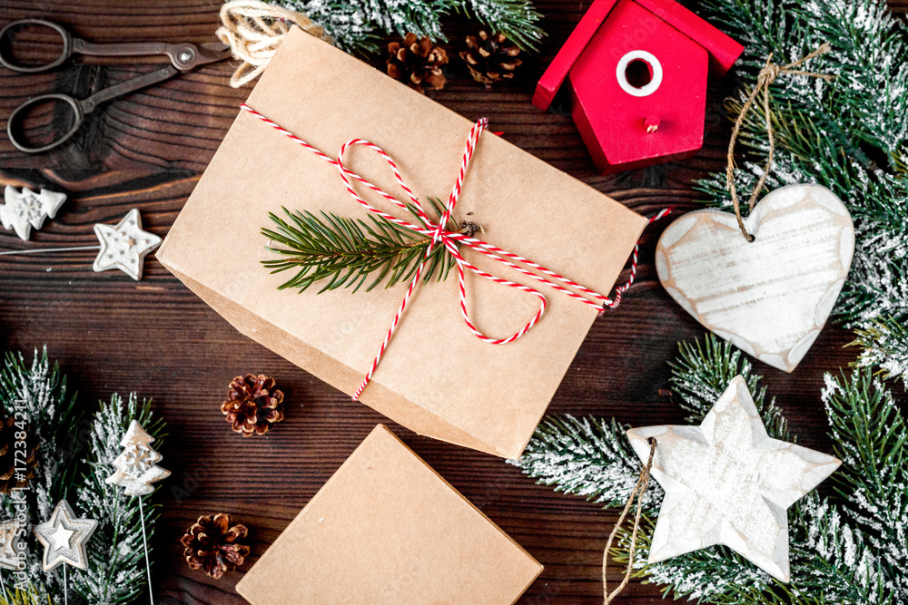 gifts boxes with fir branches on wooden background top view