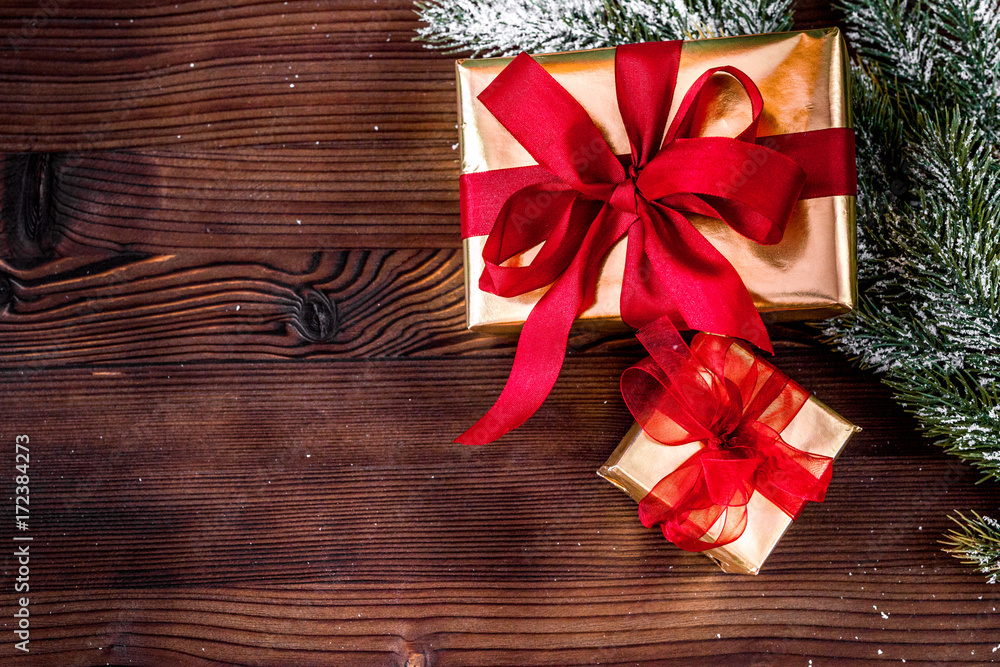 gifts boxes with fir branches on wooden background top view