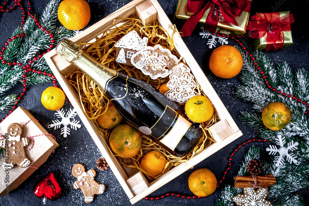 New Years champagne and tangerines in box top view