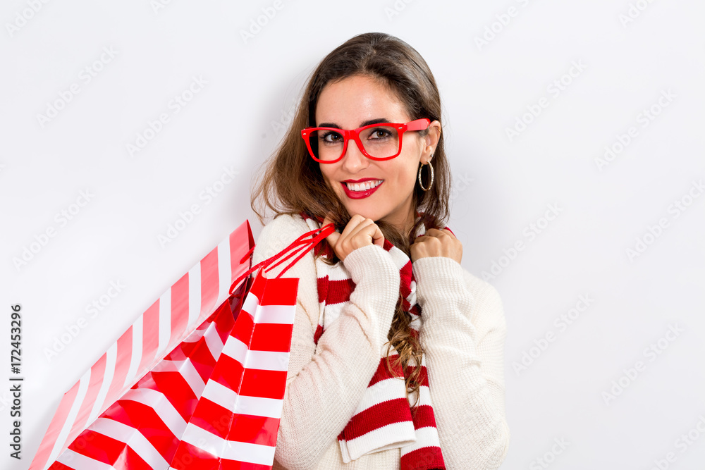 Happy young woman holding shopping bags on a white background