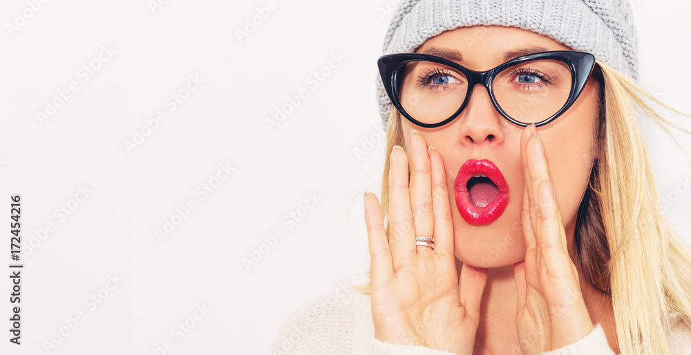 Young woman shouting on a white background