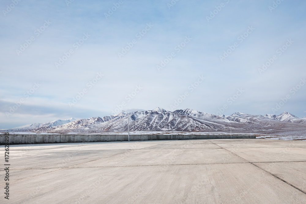 empty concrete floor with beautiful snow mountains