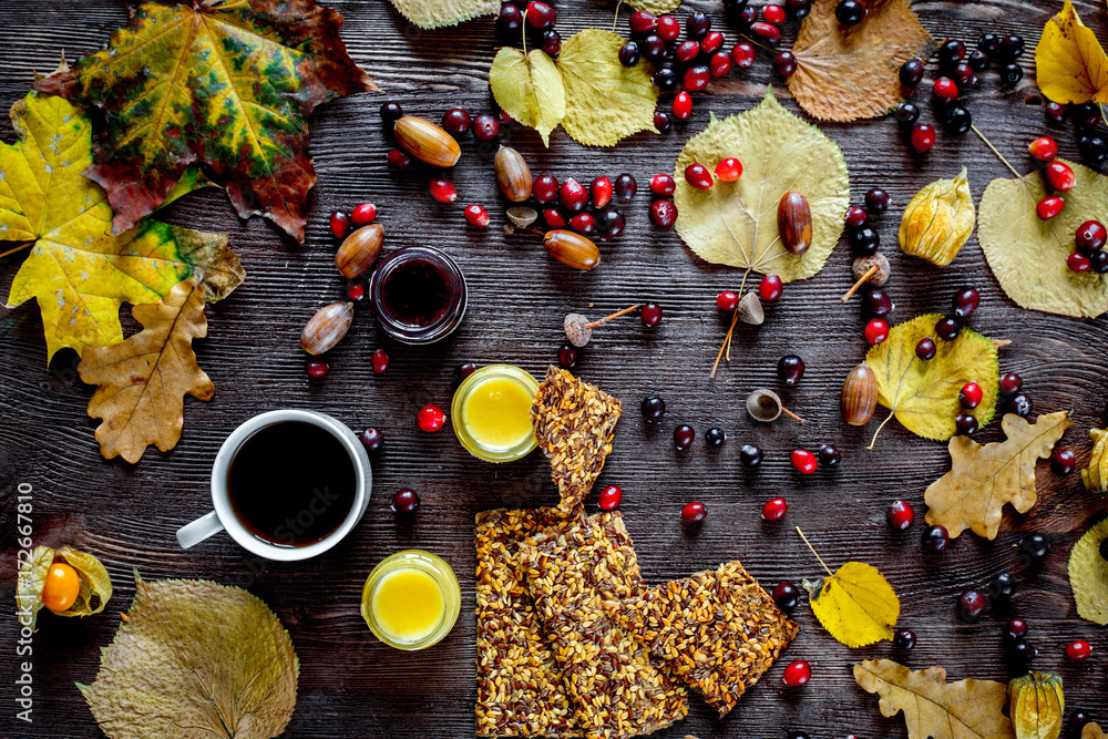 Autumn still life with honey and berries on wooden background