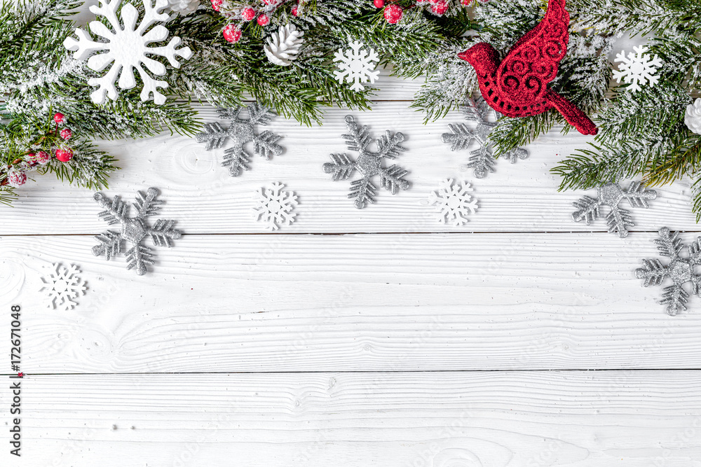 Christmas toys and spruce branches on wooden background top view