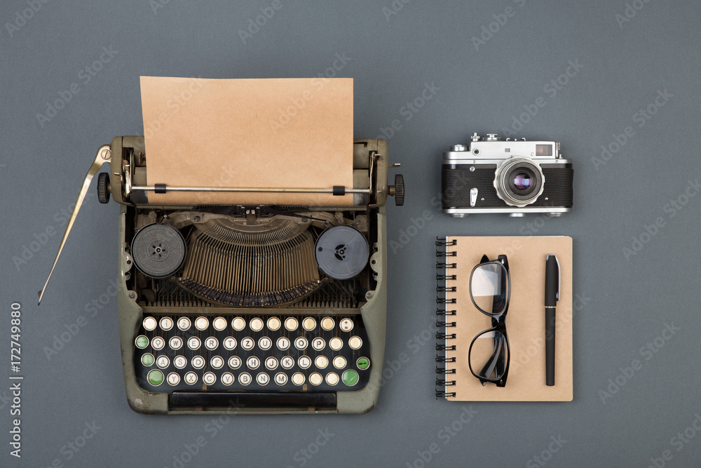 Journalist or private detective workplace - typewriter, camera, and other stuff