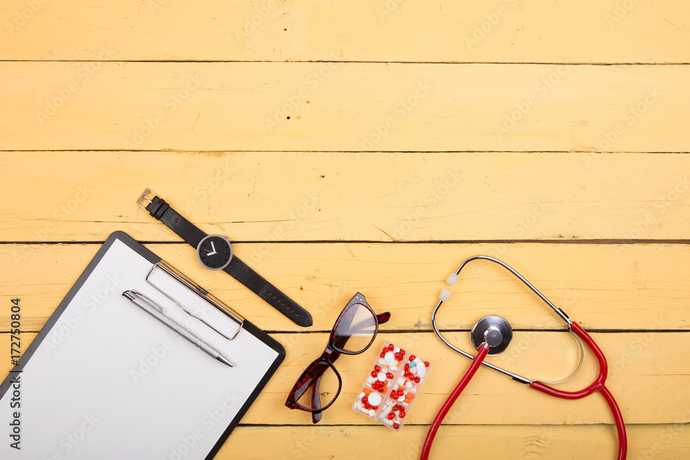 Wooden doctor desk background with stethoscope