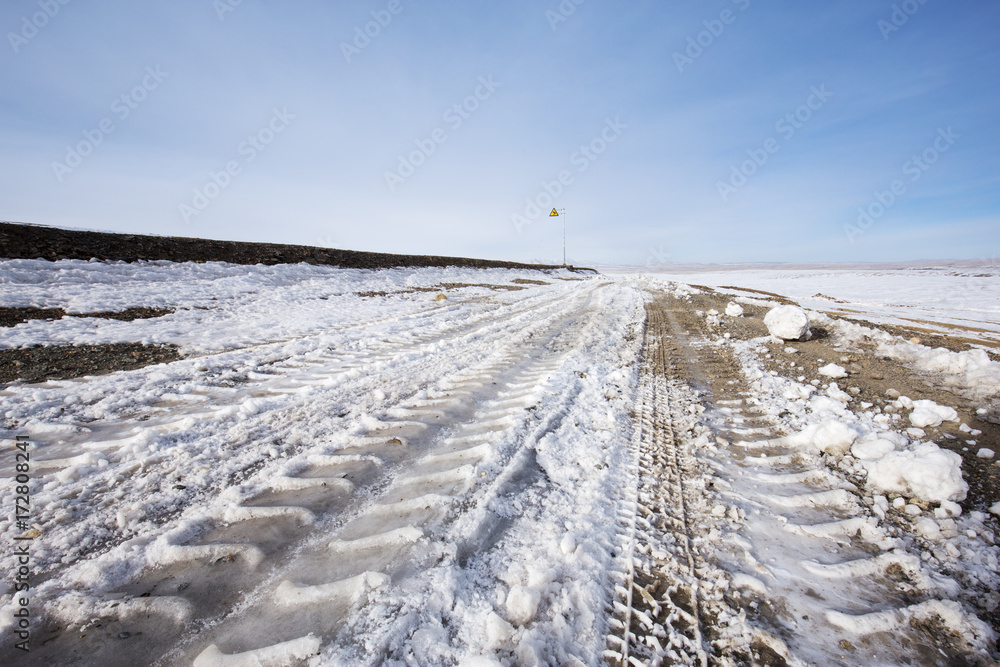 country road and hills with white snow