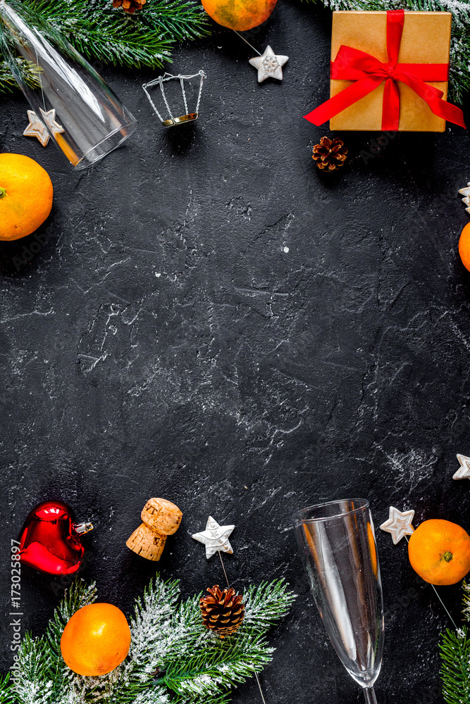 glasses and Christmas ornaments on dark background top view