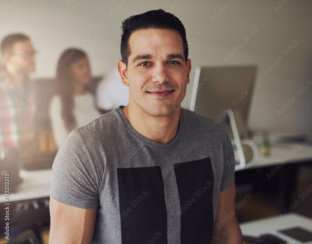 Positive young office worker looking at camera