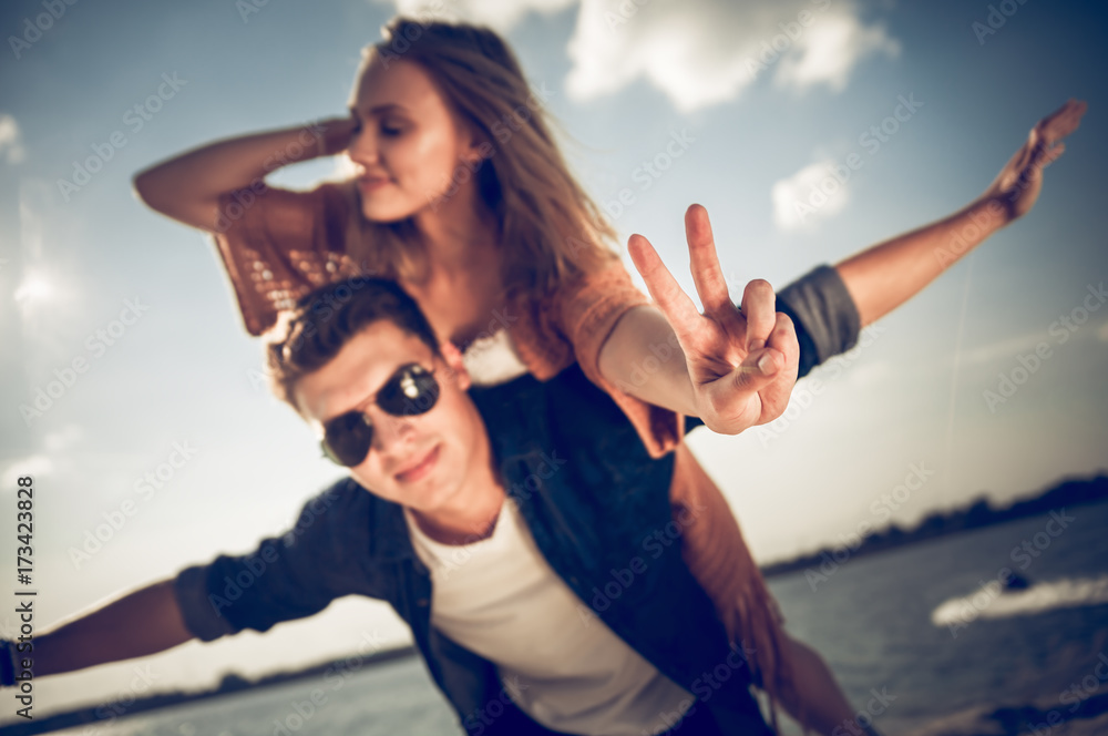 Happy couple having fun outdoor at sunset, love and friendship