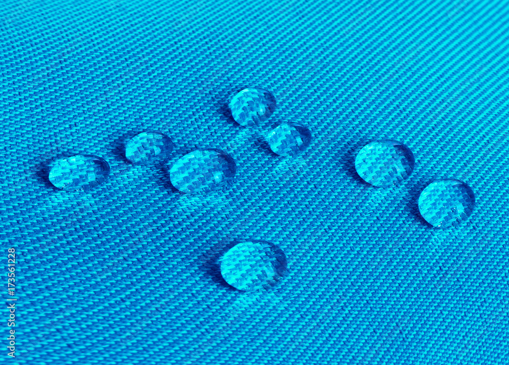 Blue waterproof fabric with waterdrops close up