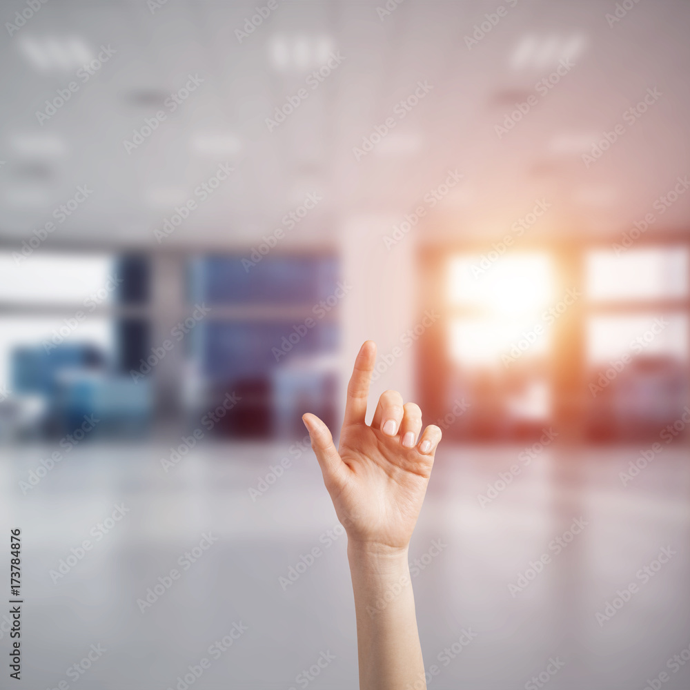 Choosing gesture of person in elegant modern interior in sunshine light