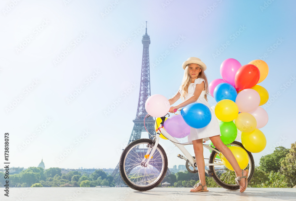 Frinch girl holding bicycle with colorful balloons