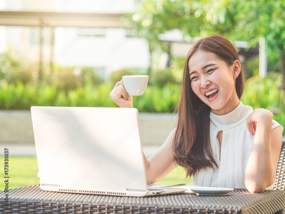 Young beautiful Asian woman working with laptop/internet/online shopping at outdoor park, smile/fres