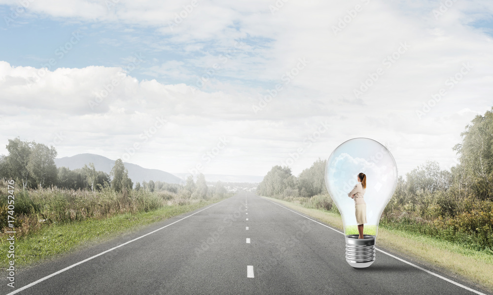 Businesswoman inside light bulb