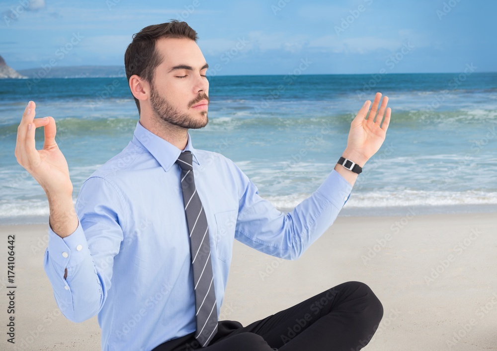 Business man meditating against beach