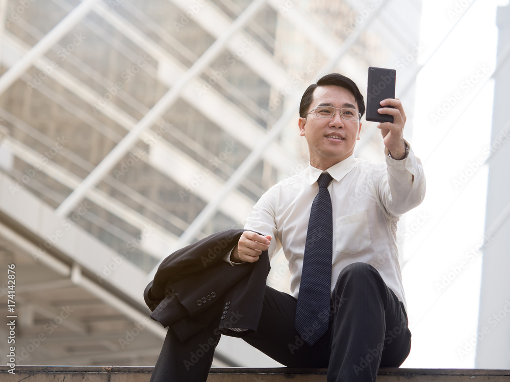 Portrait middle aged asian businessman in the city, businessman, manager, boss handsome looking in t