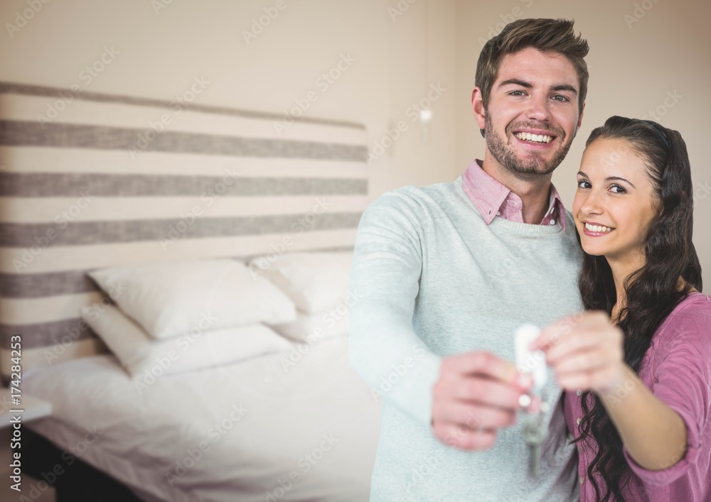 Couple Holding key in bedroom