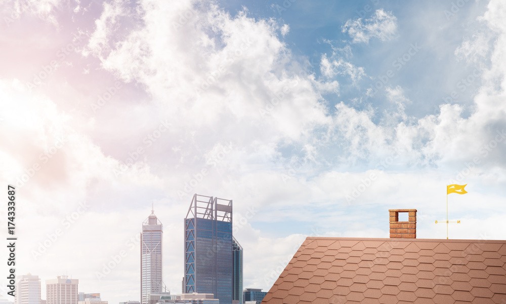 Brick house roof and modern cityscape at background