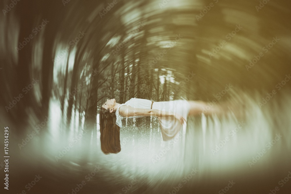 Composite image of girl in white dress floating in air