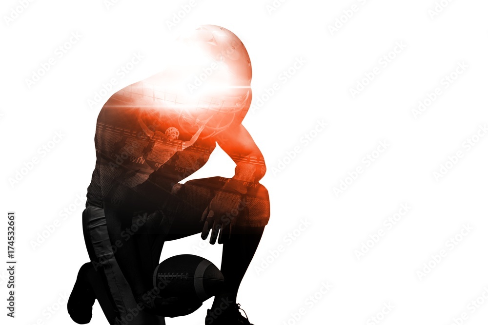 American football player kneeling while holding ball