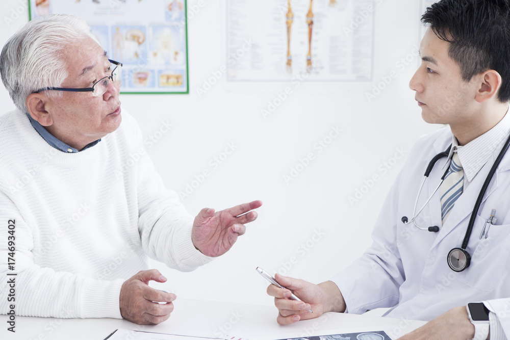 Young doctor listening to patients story