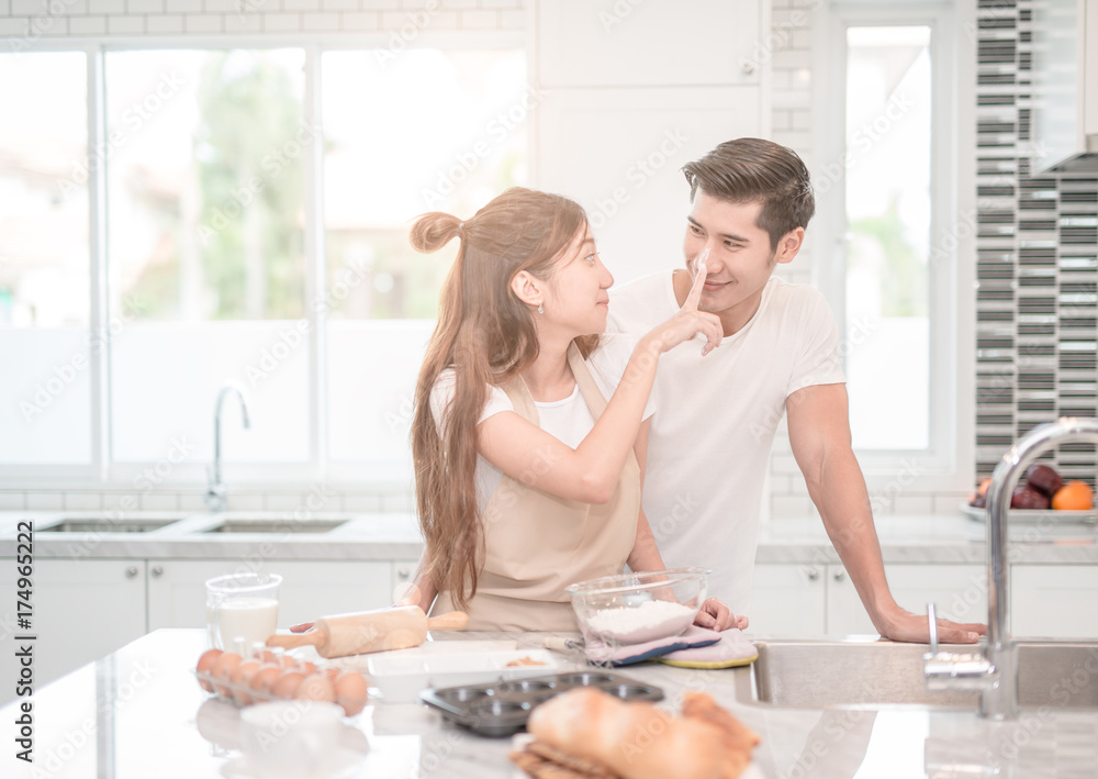 young Asian couple happy loving couple bakers helping to make dinner