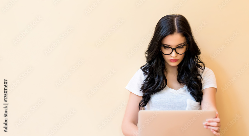 Young woman using her laptop in a big room