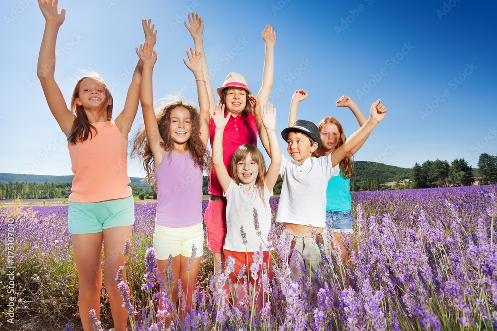 Happy kids having fun outdoors in lavender field