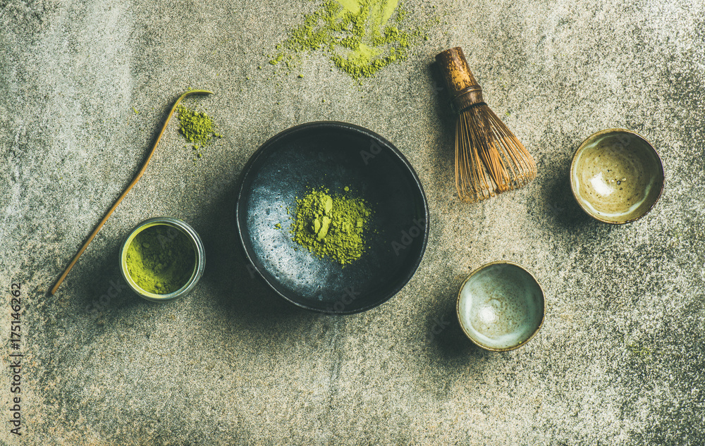 Flat-lay of Japanese tools for brewing matcha tea. Matcha powder in tin can, Chashaku spoon, Chasen 