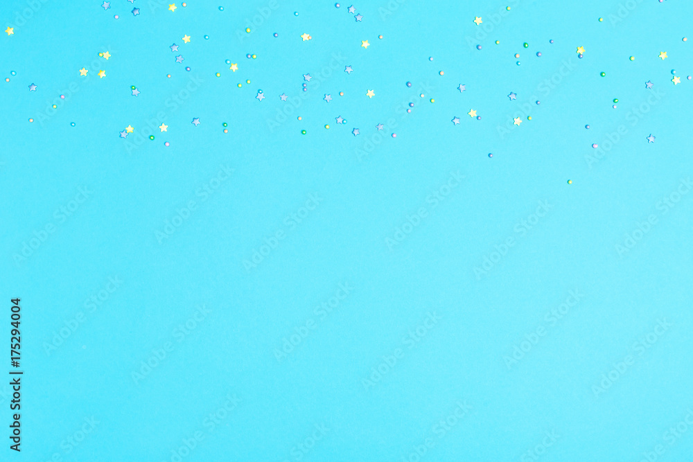 Bright blue paper background with little pastel stars