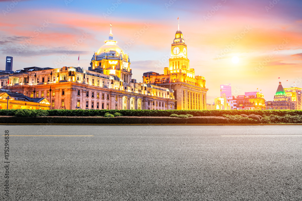 Asphalt road and modern cityscape in Shanghai at sunset