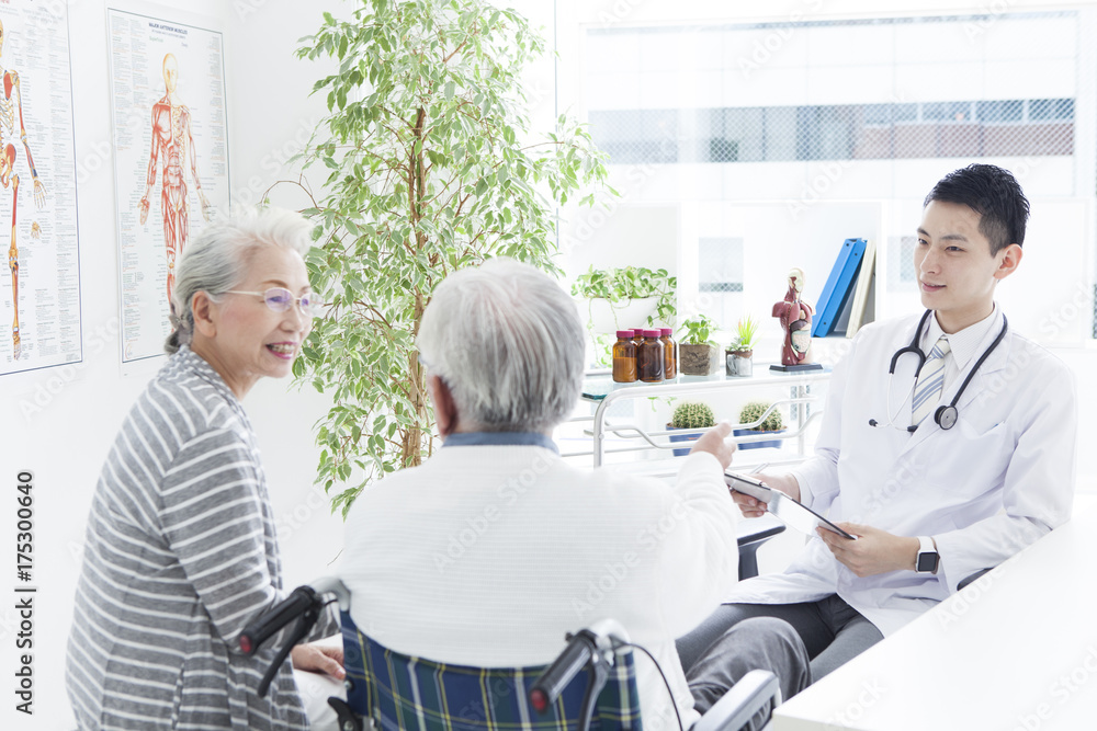 A young doctor and an elderly patient have a happy conversation