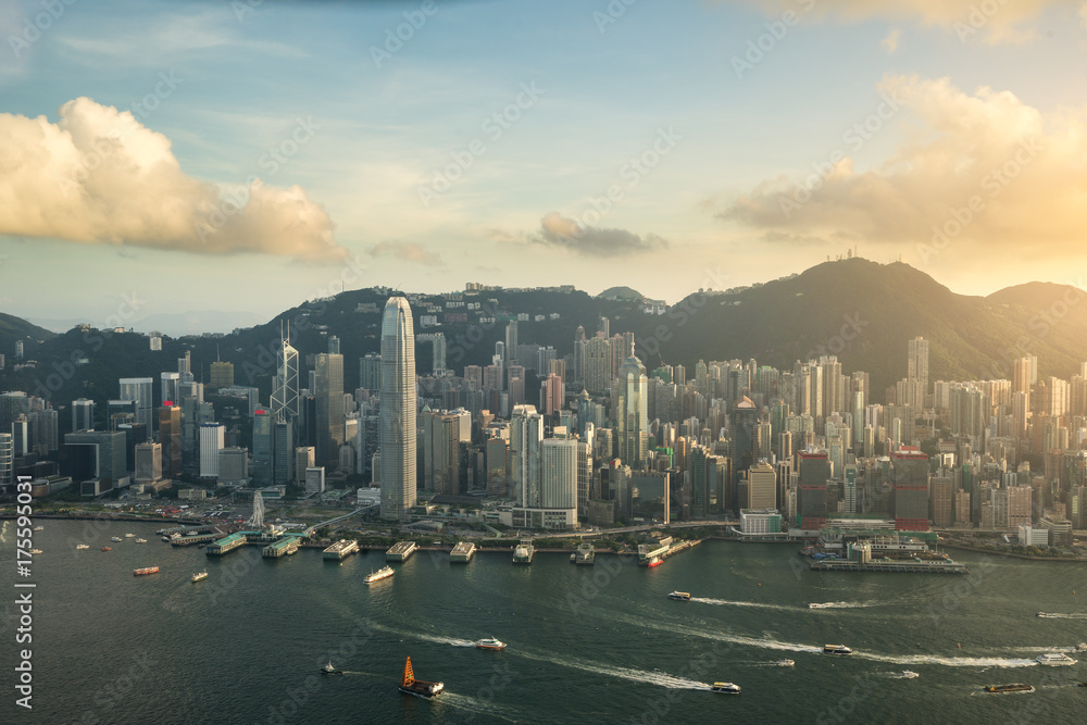 Aerial view of Hong Kong skyline and Victoria Harbor with blue sky in Hong Kong. Asia..