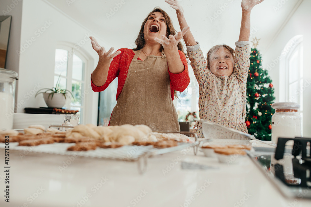 Mother and daughter having fun while making Christmas cookies.